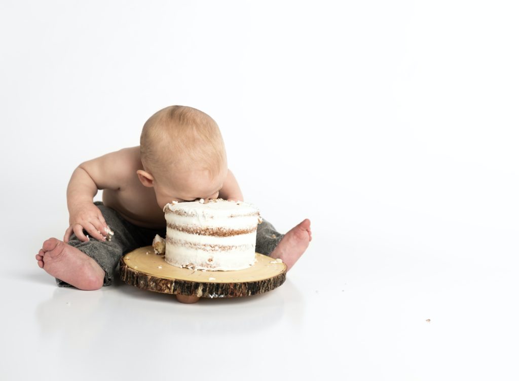 best apps for new moms 10 - baby smashing his face into a cake.