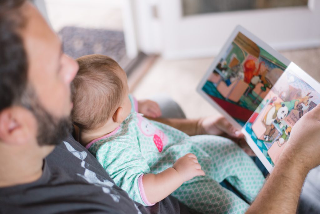 best app for new moms 4 - baby looking at a book 
